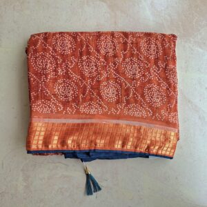 Brown bandhani saree with silk border and contrast blouse